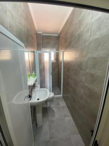 a bathroom with a sink and a shower at Al hoceima Center Apartment in Al Hoceïma +6 photos