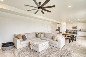 a living room with a couch and a ceiling fan at American Fork Home about 8 Mi to Thanksgiving Point! in American Fork