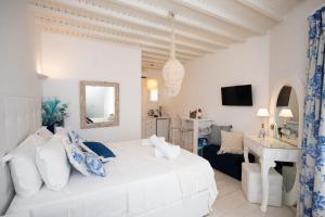 a white bedroom with a bed and a desk at Fino Amore Private Jacuzzi Suite in Mykonos Town in Mikonos