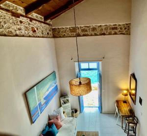 a person laying on a couch in a living room at Villa Hiona-Seafront Villa in Halki