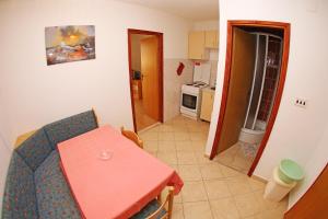 a small kitchen with a table and a dining room at Apartments and Rooms Zvjezdana in Hvar