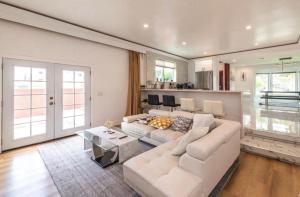 a living room with a white couch and a table at Contemporary Private Room 7 in Los Angeles