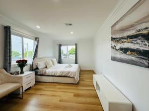 a white bedroom with a bed and a window at Contemporary Private Room 7 in Los Angeles