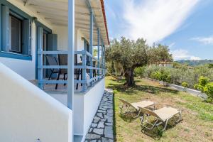 a view from the balcony of a house with a table and chairs at Anesis Apartment 1 in Panormos Skopelos