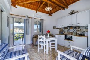 a kitchen and living room with a table and chairs at Anesis Apartment 1 in Panormos Skopelos