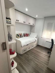 a small bedroom with a bed and a window at Apartamento céntrico con terraza EBI02919 in Portugalete