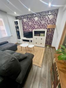 a living room with a couch and a table at Apartamento céntrico con terraza EBI02919 in Portugalete