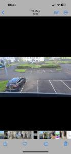 a television screen with a car parked in a parking lot at Port Miller in Portstewart