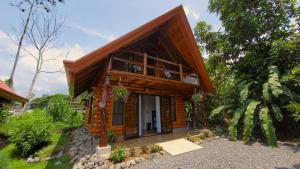 a small wooden house in the middle of a forest at Arenal Sweet Cabins in Fortuna