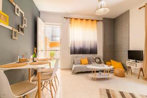 a living room with a table and a couch at Lilliput Garden in Rhodes Town