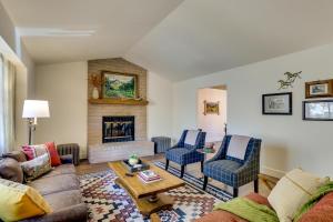 a living room with a couch and a fireplace at Pet-Friendly Escape with Game Room and Fire Pit! in North Fork