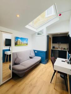 a living room with a couch and a window at Sun Guest House Cambridge in Cambridge