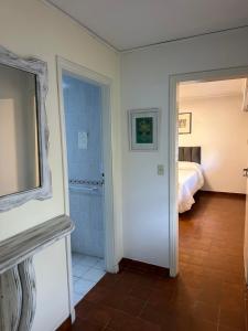 a room with a bedroom with a bed and a mirror at LPR Express in Monte Grande