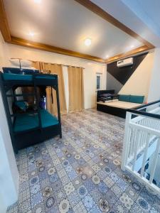 a living room with a tv and a bed at Casita ni Raphaella in Tacloban