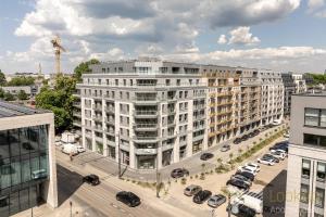 an overhead view of a large white building with a parking lot at Diasfera Prestige by LookAp in Łódź