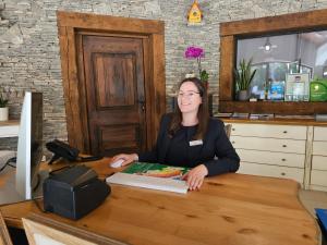 a woman sitting at a desk with a computer at Amadria Park Camping Trogir - Mobile Homes 2 in Seget Vranjica +47 photos