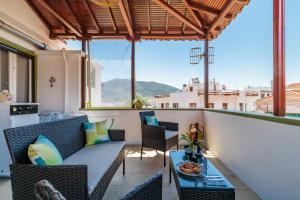 a balcony with a table and chairs with a view at Sofia's House - Skopelos Town in Skopelos Town