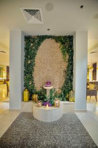 a room with a wall covered in ivy at Radisson Blu Resort, Fujairah in Dibba