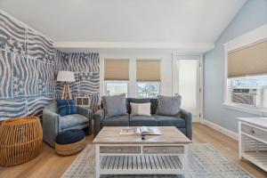 a living room with a couch and a table at Newly Renovated Professional Design Partial Ocean Views in Hampton +41 photos