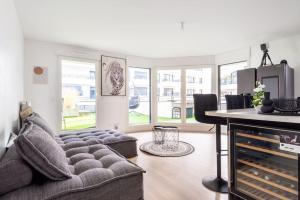 a living room with a couch and a table at Résidence Abraham-Guest Room 1 LaDéfense U-Arena #Terasse #Fibre #View in Colombes