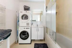 a white laundry room with a washer and dryer at Résidence Abraham-Guest Room 1 LaDéfense U-Arena #Terasse #Fibre #View in Colombes +48 photos