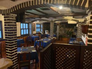 a dining room with blue tables and chairs at Hotel brisas del mar 2022 in Catia La Mar