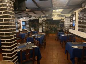 a dining room with blue tables and chairs at Hotel brisas del mar 2022 in Catia La Mar