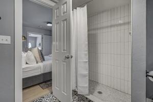 a room with a bed and a door with a bathroom at Neighborly Heights - Downtown King BBQ Fire Pit in Colorado Springs +46 photos