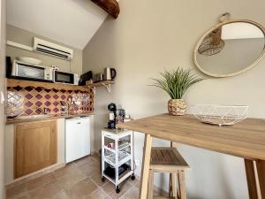 a kitchen with a wooden table and a mirror at Lodge Paradisiaque Spa in Cazouls-lès-Béziers +23 photos