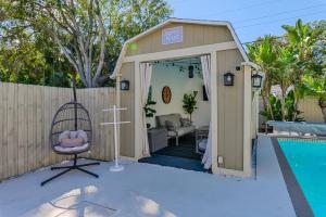 a shed with a swing next to a pool at Pool Home Close to the Beach and Downtown in Seminole