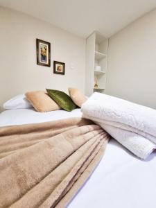 Ένα ή περισσότερα κρεβάτια σε δωμάτιο στο Flat Aconchego - Diamantina MG