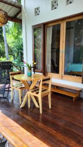a wooden table and chairs on a wooden deck at VidFauw Oasis Villa 
