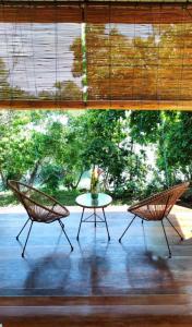 2 sillas y una mesa frente a una ventana en VidFauw Oasis Villa 