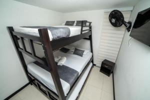 two bunk beds in a small room with a fan at Apartahotel cerca del Parque del Café, 405A in Montenegro +36 photos