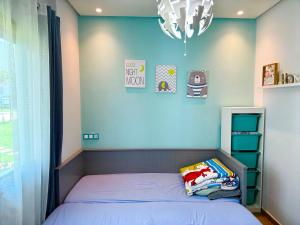 a small bedroom with a bed and a chandelier at Sidi rahal Blue beach in Sidi Rahal +23 photos