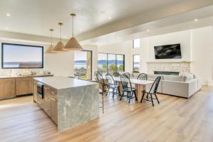 a kitchen and living room with a table and chairs at Luxe Retreat with Theater Room Walk to Bear Lake! in Garden City