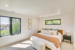 a bedroom with a bed and a chair and windows at Luxe Retreat with Theater Room Walk to Bear Lake! in Garden City +33 photos