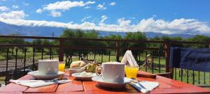 a table with food and drinks on top of a table at Ayres del Golf Posada-Restó in Merlo