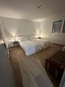 a bedroom with a large bed with two lights on it at Casa Abuela Ángela in Granja de Moreruela