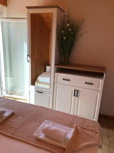 a dressing room with a mirror and a bed at Apartments Ruza in Ražanj