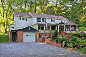 a house with a flag on the front of it at Creekside Farmstead Hot Tub with Brand New Pool and BBQ in Auburn