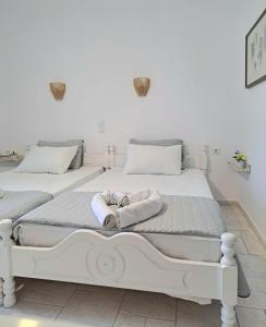 Dos camas en una habitación blanca con toallas. en Orion Studios C, en Centro histórico de Alónnisos 13 fotos más