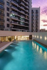 a large swimming pool in front of a building at Premium tower apart Parking gratis in Cordoba