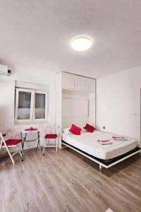 a bedroom with a bed and two chairs and a table at Apartments by the sea Duboka, Neretva Delta - Usce Neretve - 23268 in Klek