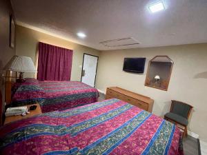 Postel nebo postele na pokoji v ubytování Ankur Inn Motel