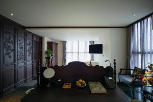 a room with a bed and a table with fruit on it at Amanaki Thao Dien in Ho Chi Minh City