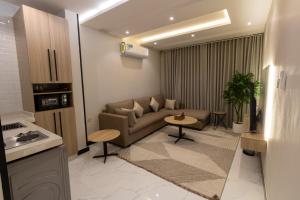 a living room with a couch and a table at Elite House in Taif