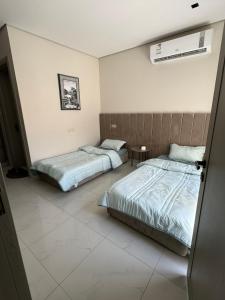 Katil atau katil-katil dalam bilik di شاليه الإفرند الفندقي فيلا