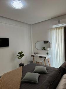 a bedroom with a large bed and a desk at Cozy City Center Apartment in Rhodes Town