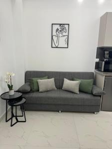 a living room with a gray couch and a table at Cozy City Center Apartment in Rhodes Town
